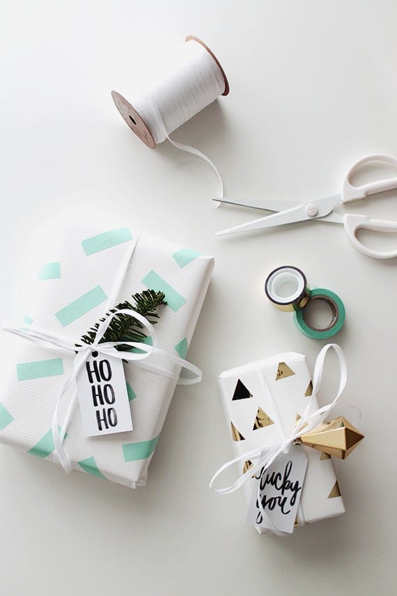 Christmas presents wrapped in DIY washi tape paper gold and mint green designs.