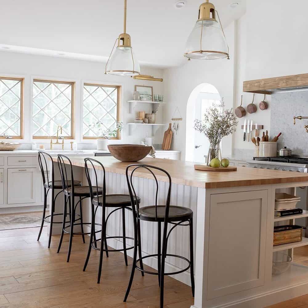 Custom designed kitchen with greige cabinets and island. Black high-backed stools in European farmhouse style.