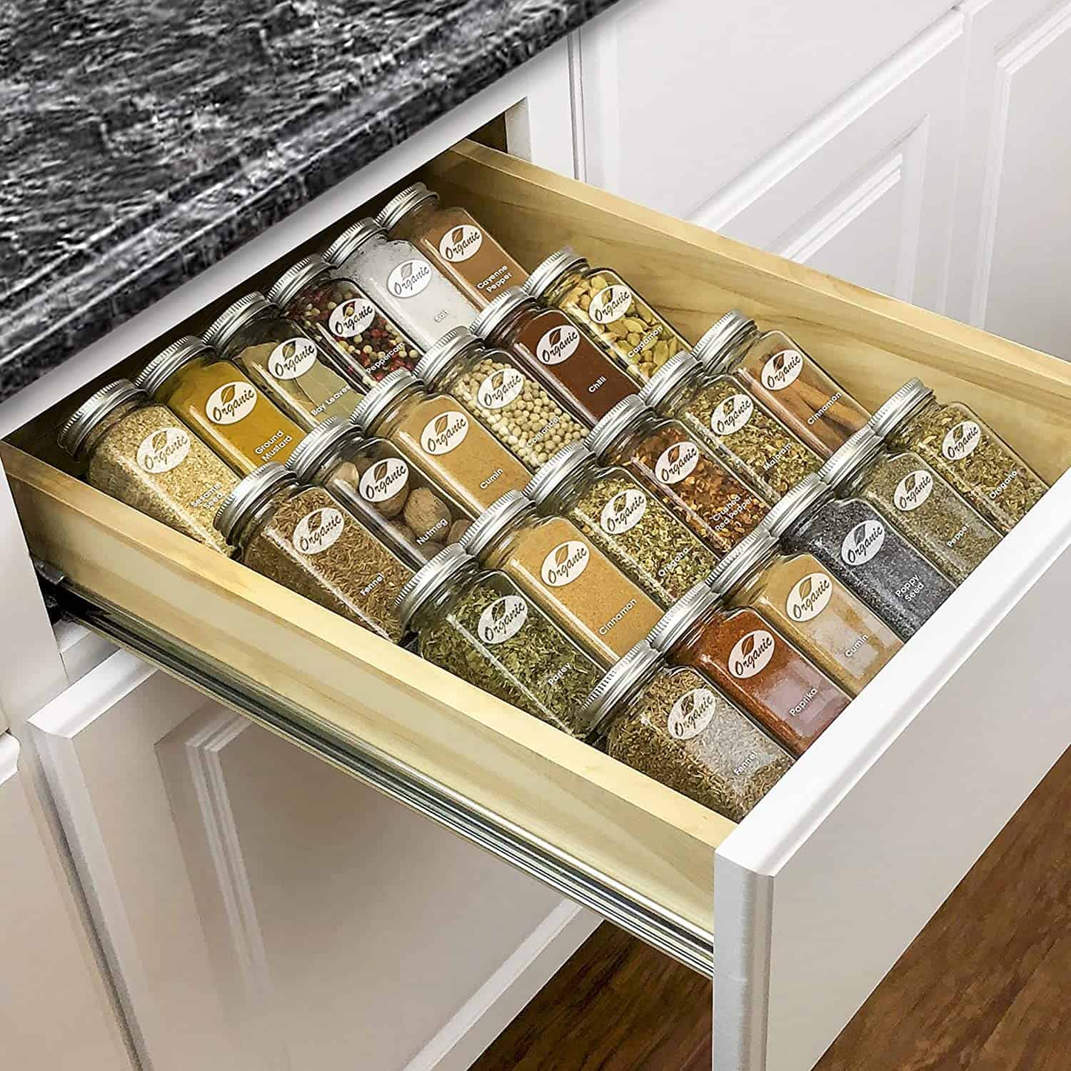 Four-tier in-drawer spice rack tray with organized spices.