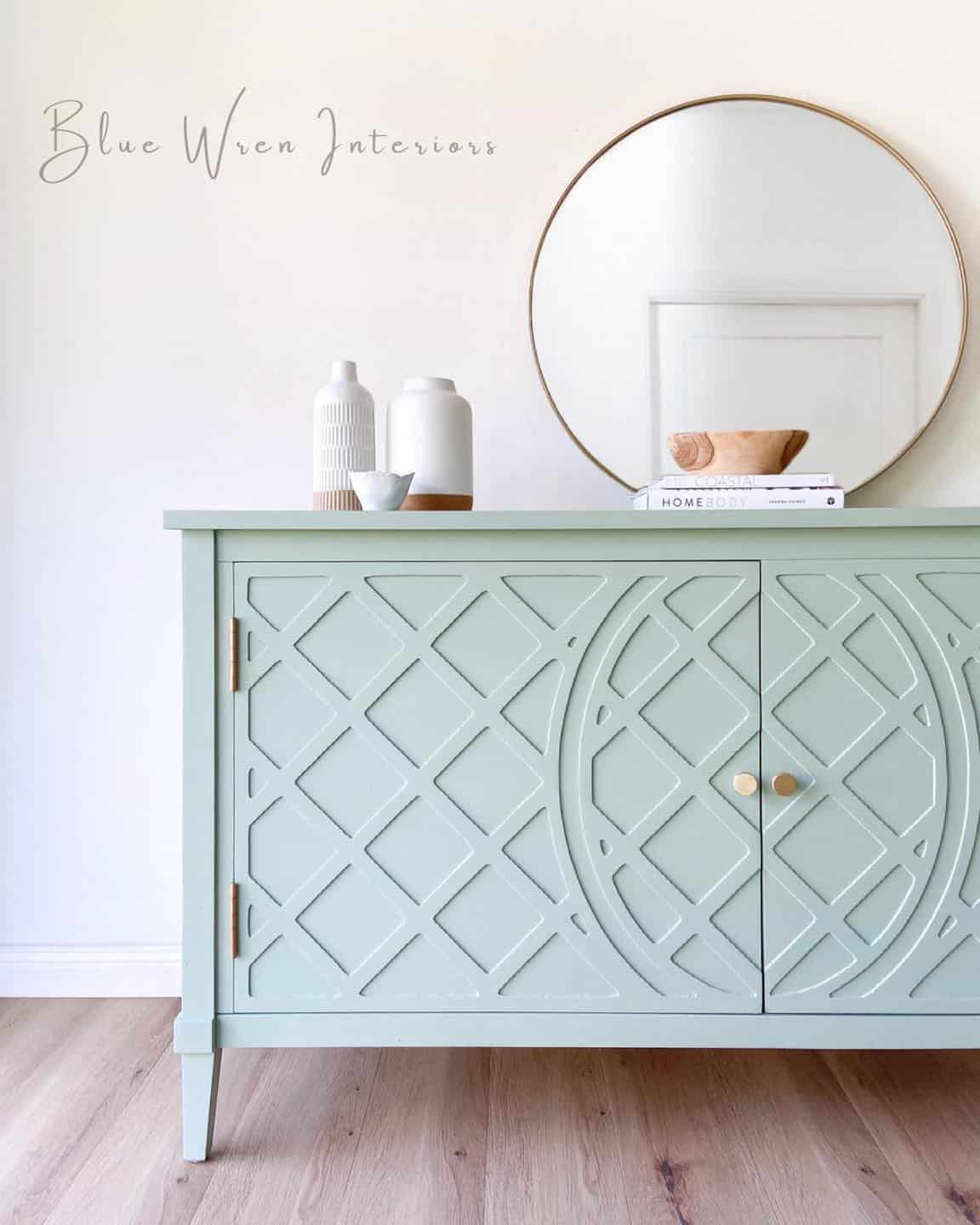 Sage Green dresser with brushed gold hardware on beach grey hardwood floors.