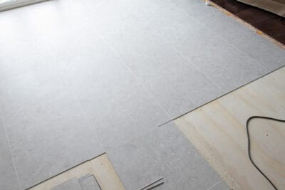 Luxury vinyl tile laid out while being installed.