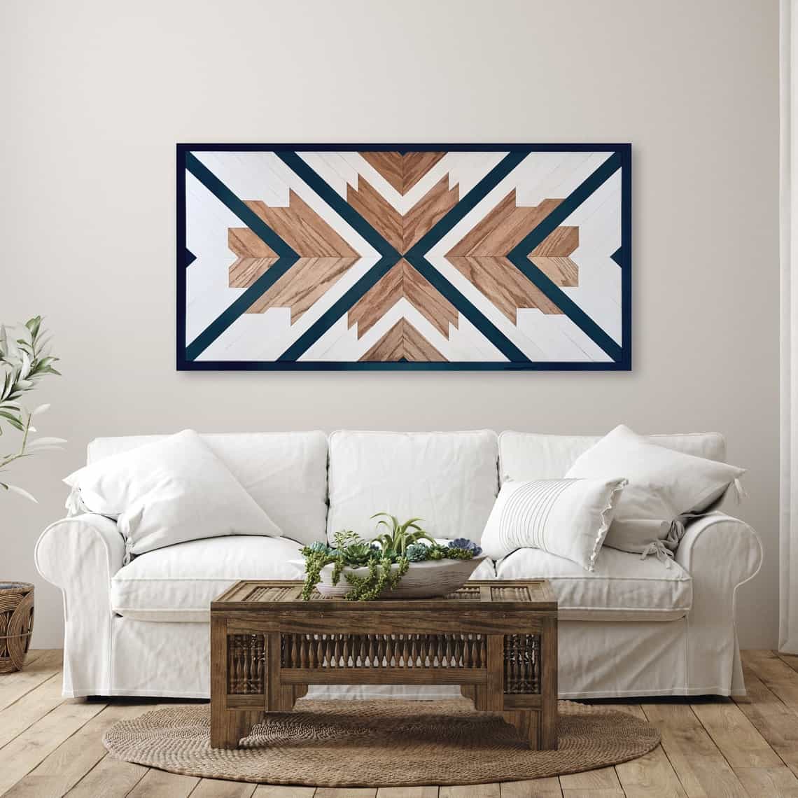 Modern geometric wood wall art with navy accents on neutral painted wall in a living room above the couch.