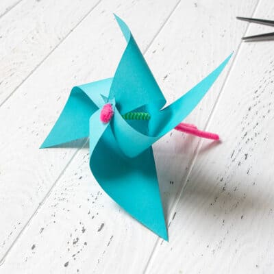 Paper windmill with pipe cleaner through it.