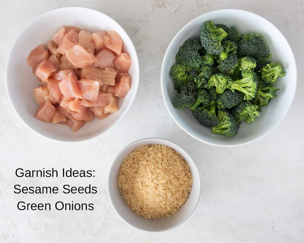 Three bowls with chicken pieces, broccoli florets, and rice in them.