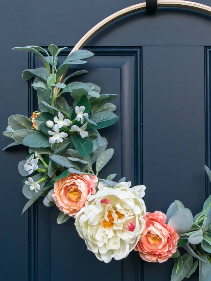 Spring hoop wreath closeup with peonies, roses, and lamb's ear.