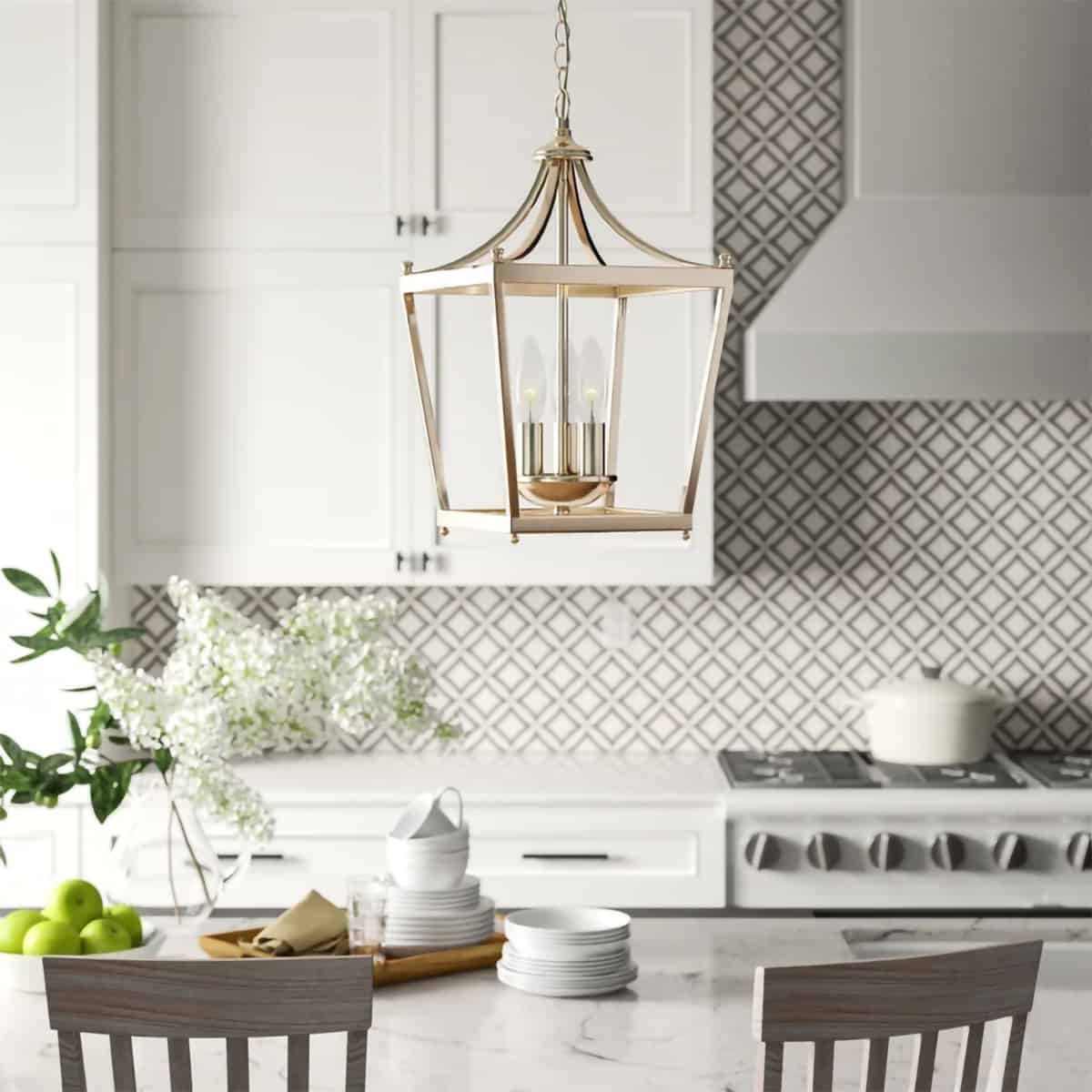 Silver traditional lantern style pendant lamp with candle style lights centered above marbled island in country French kitchen featuring grey and white backsplash.