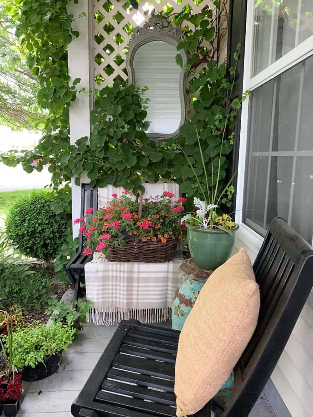 Summer decorated porch with hanging divider, bench, and decorations.