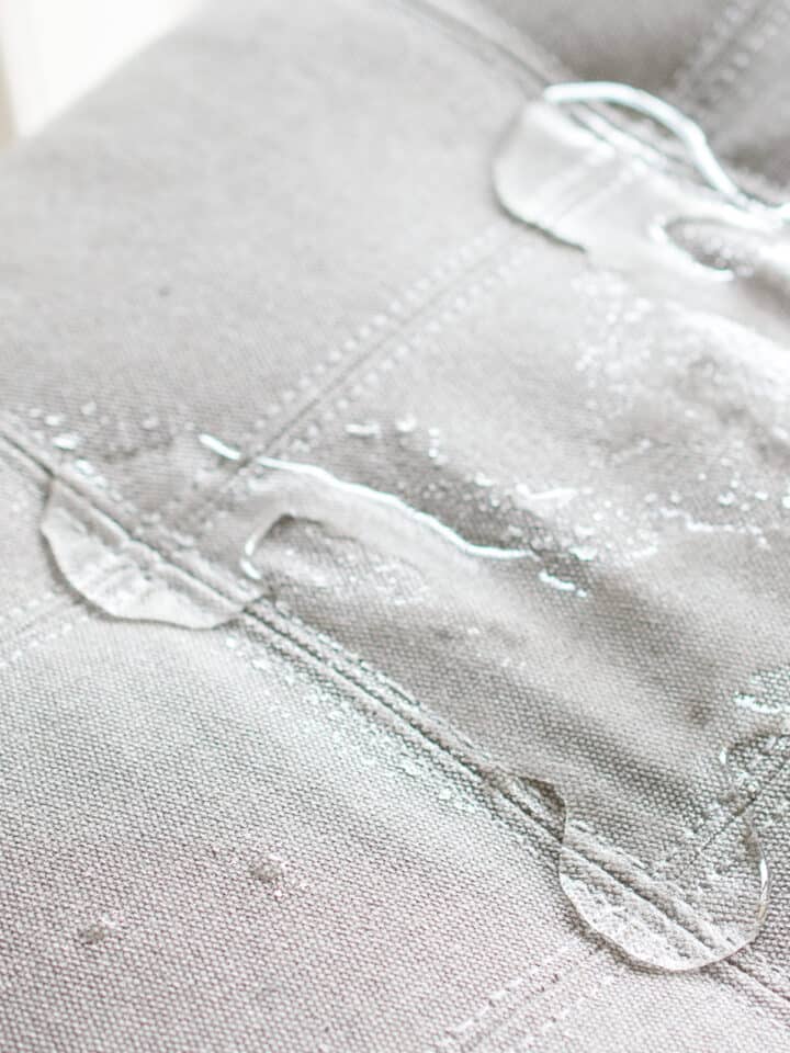 Water beading on fabric after spraying with water repellant.