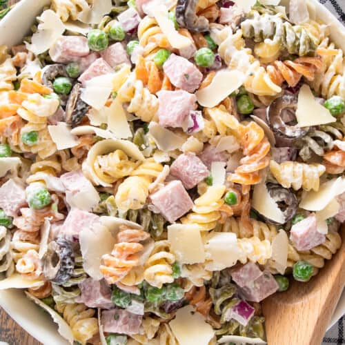 Tricolor Pasta Salad with creamy dressing in a bowl with a spoon.