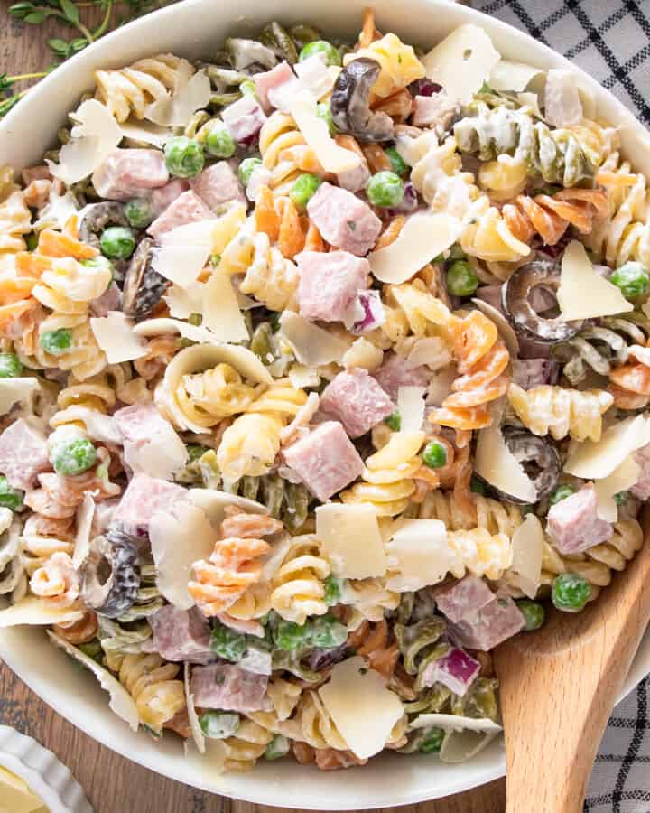 Tricolor Pasta Salad with creamy dressing in a bowl with a spoon.
