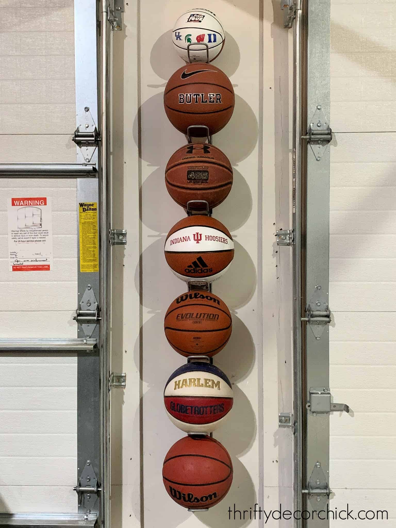 Sports ball storage between two garage doors.