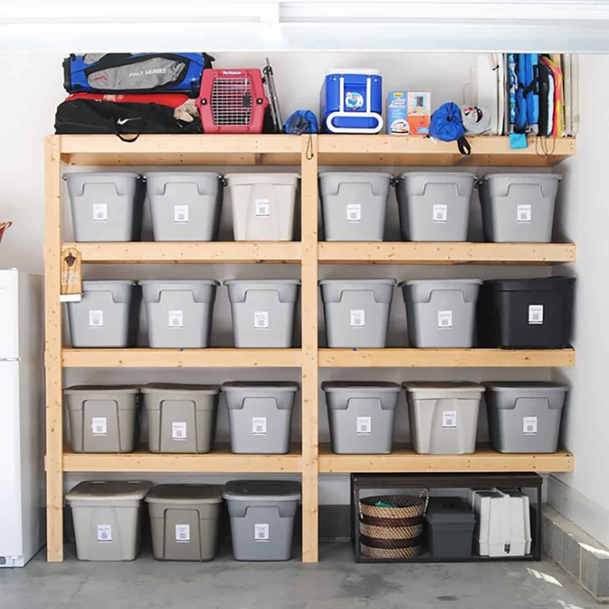 A large DIY garage shelves with storage bins in each of the four shelves.