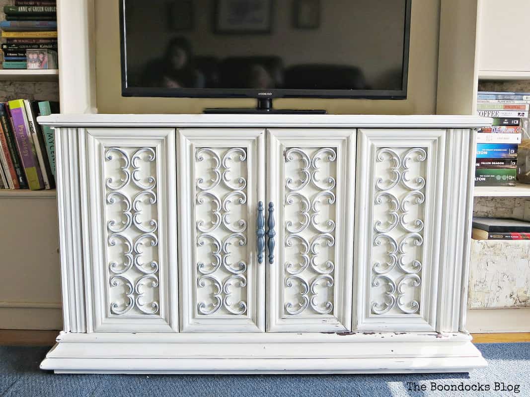 White painted antique sideboard with ornate carved details.