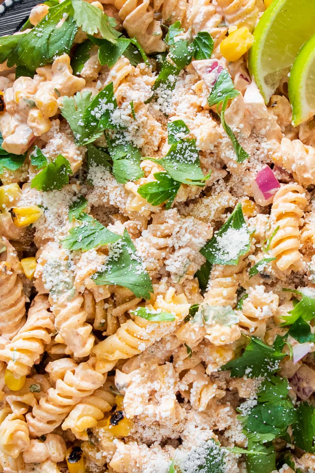 Closeup of Mexican pasta salad with cilantro sprinkled on top.