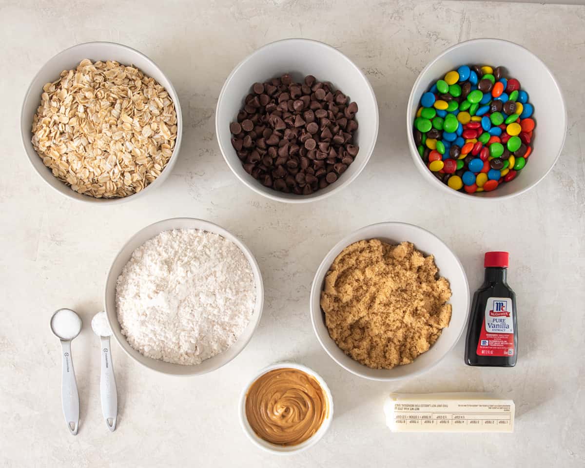 Ingredients for monster cookie bars laid out on a table.