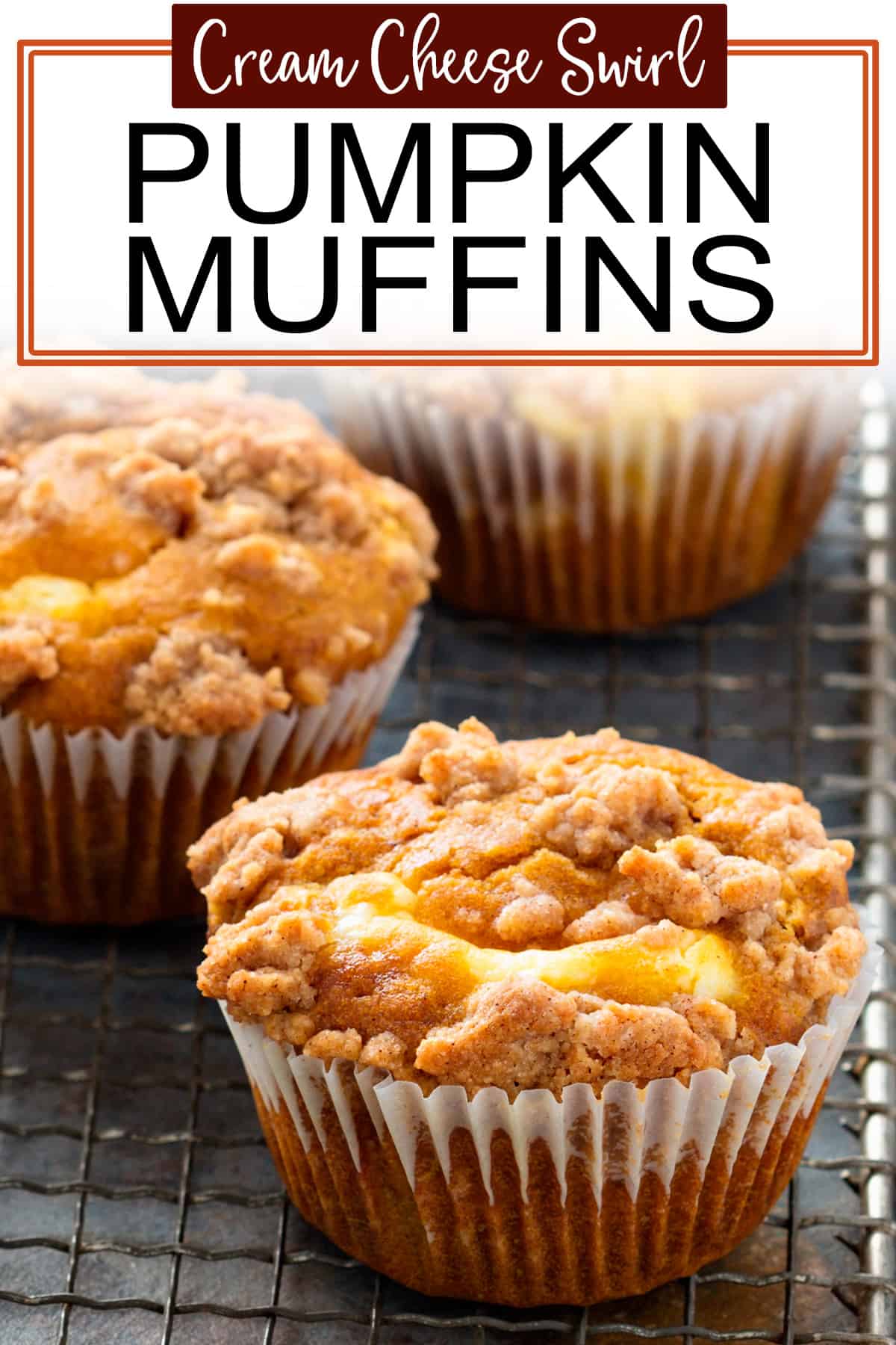 Closeup of pumpkin cream cheese muffins on a wire rack with recipe post title.
