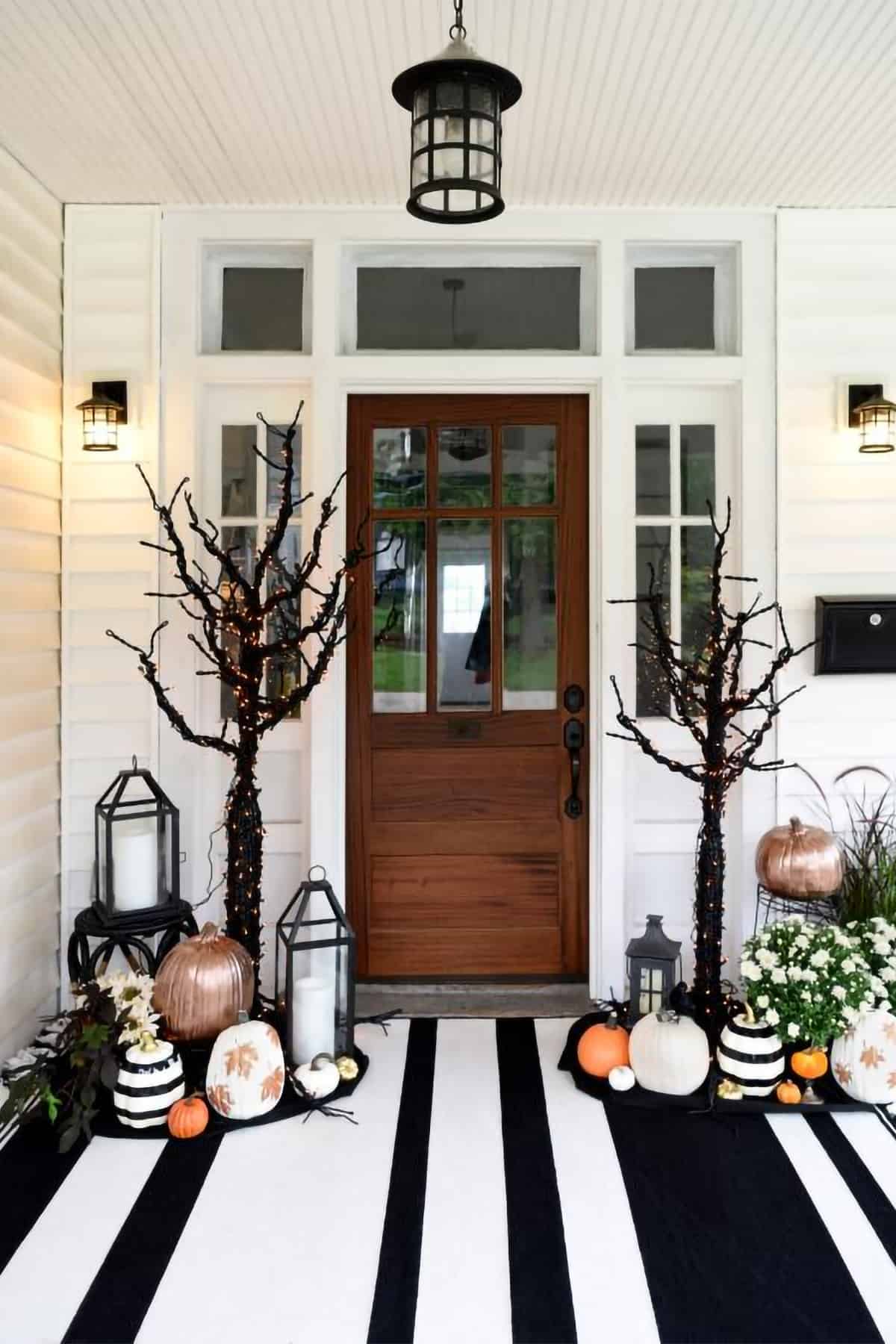 Halloween porch decor with bold black and white décor on a white house.