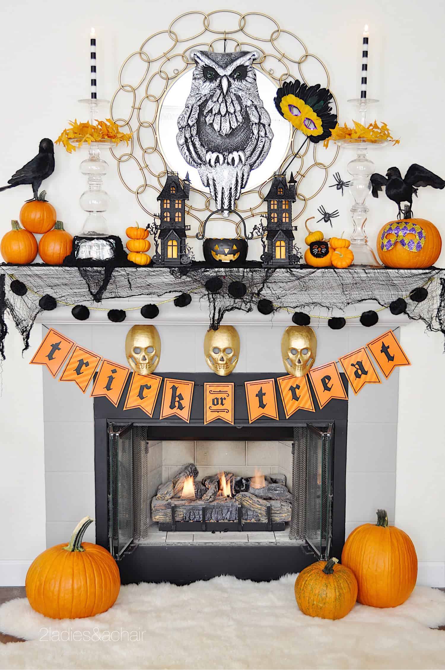 Spooky mantle with bats, birds, and pumpkins.
