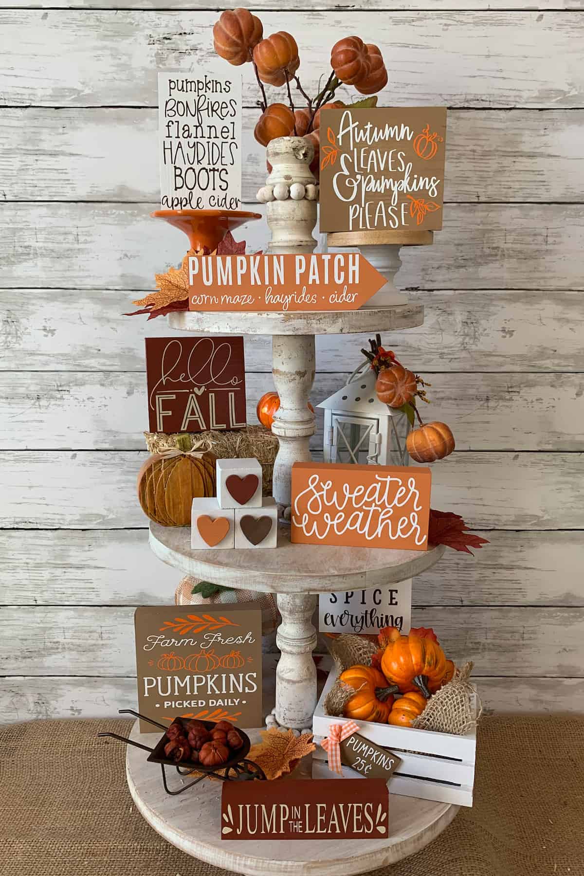 Thanksgiving and fall themed decorations on a white stand.
