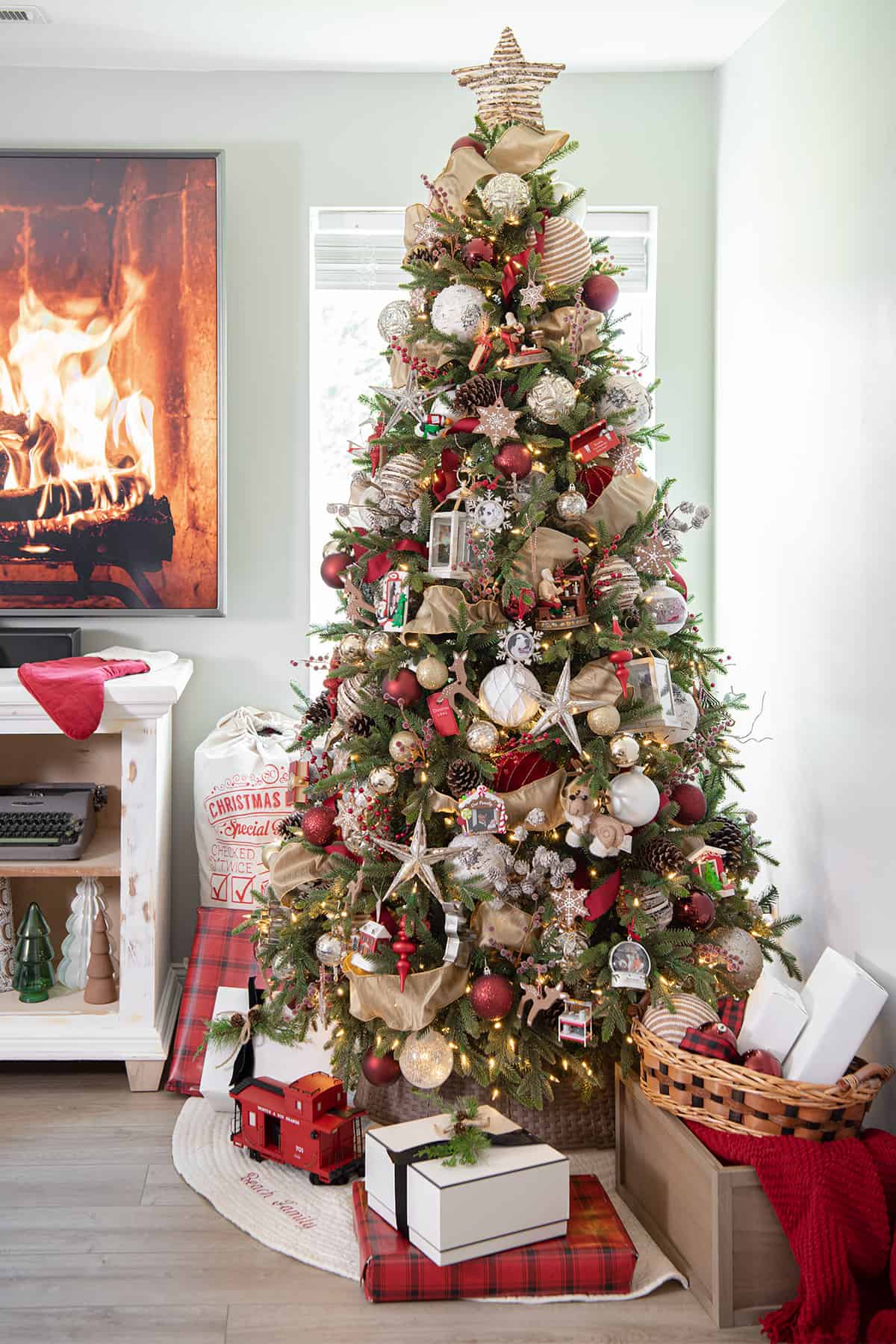 Gingerbread themed red and gold Christmas Tree in the corner of a living room.