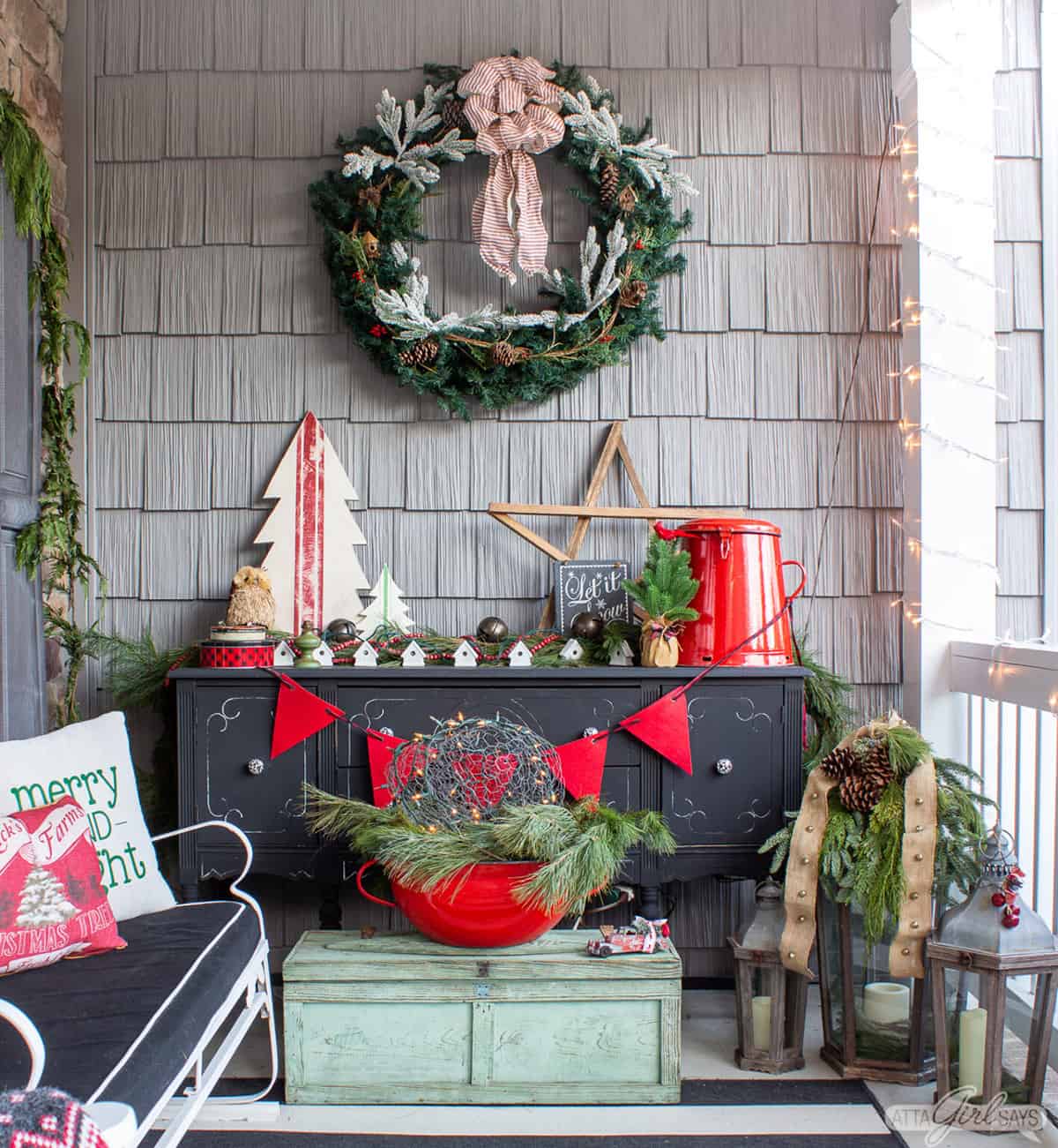 Vintage Christmas porch with red and black decorations in a porch Christmas tree theme.