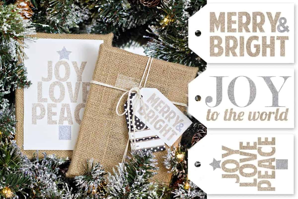 Two packages over pine branches with glittery gold tags.