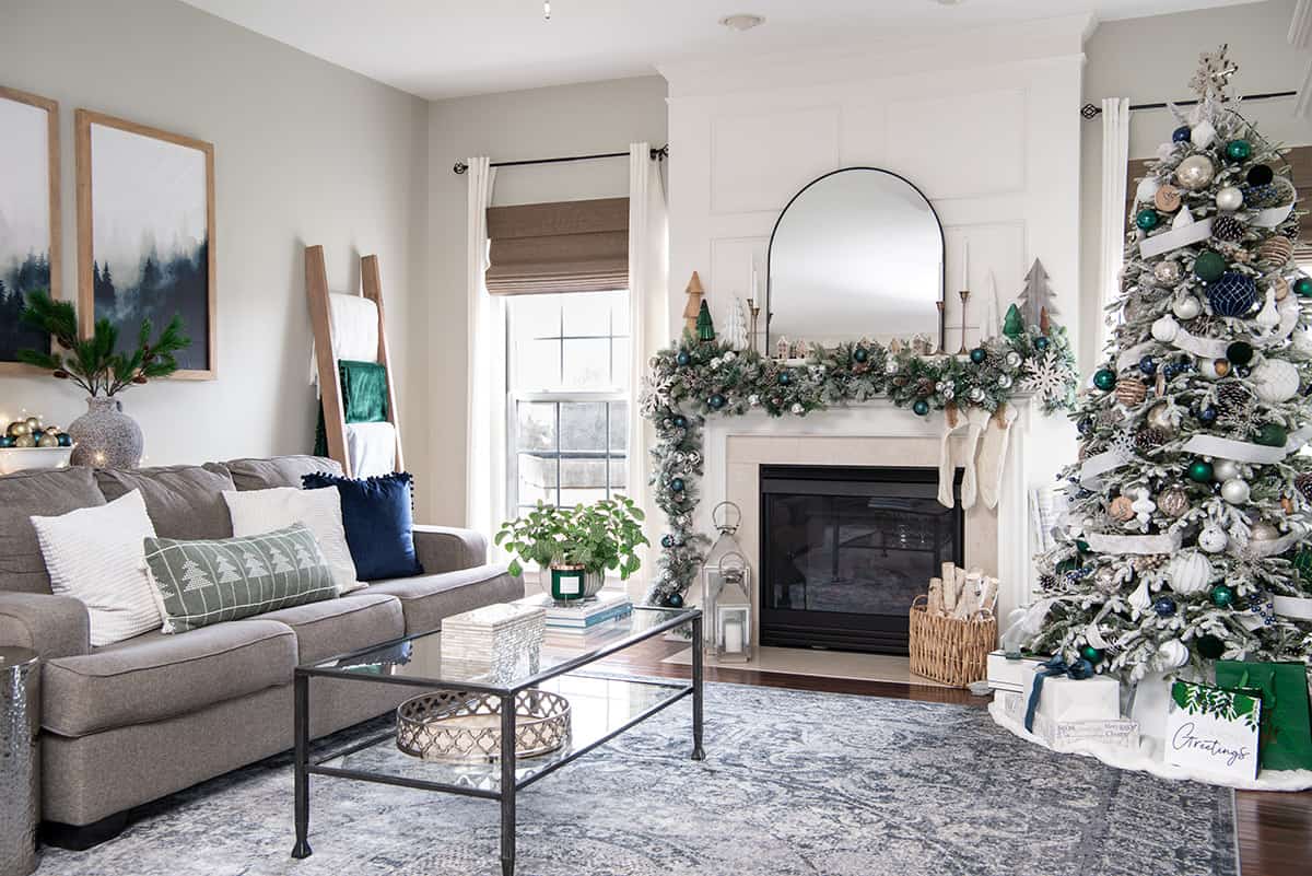Neutral Beige living room with hunter green and navy accents adorned with winter wonderland decorations for an airy lodge setting.