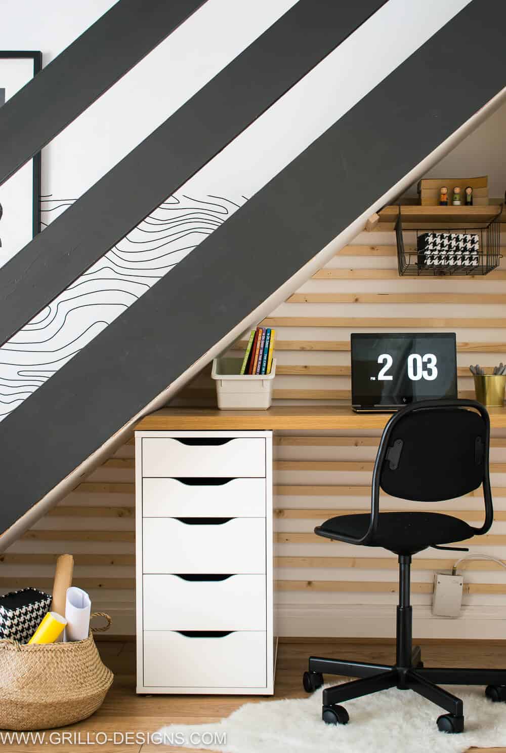 Black and white homework station under a staircase.