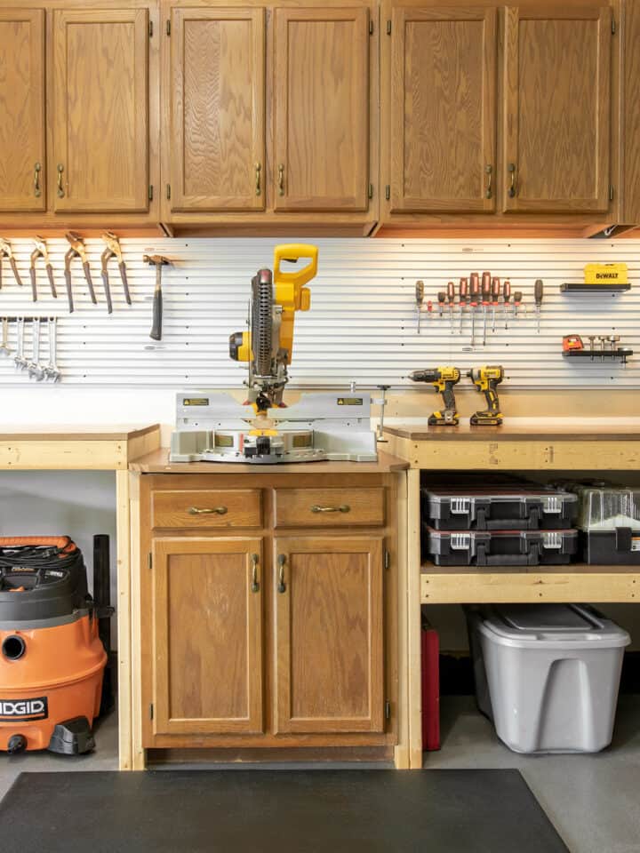 Organized Garage workbench with cabinets and tools in cases.