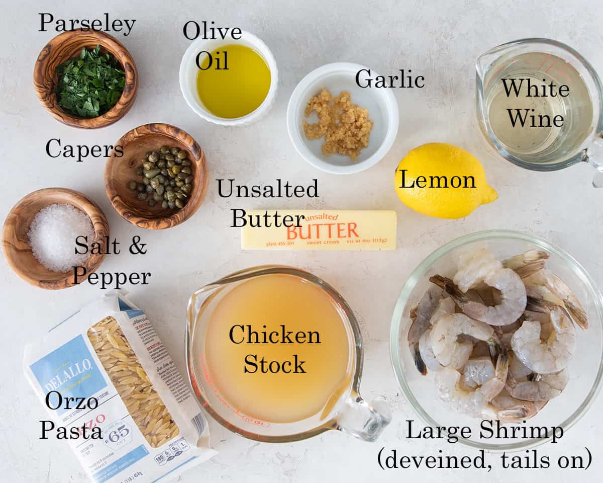 Lemon garlic shrimp and orzo ingredients for a recipe laid out on a table.