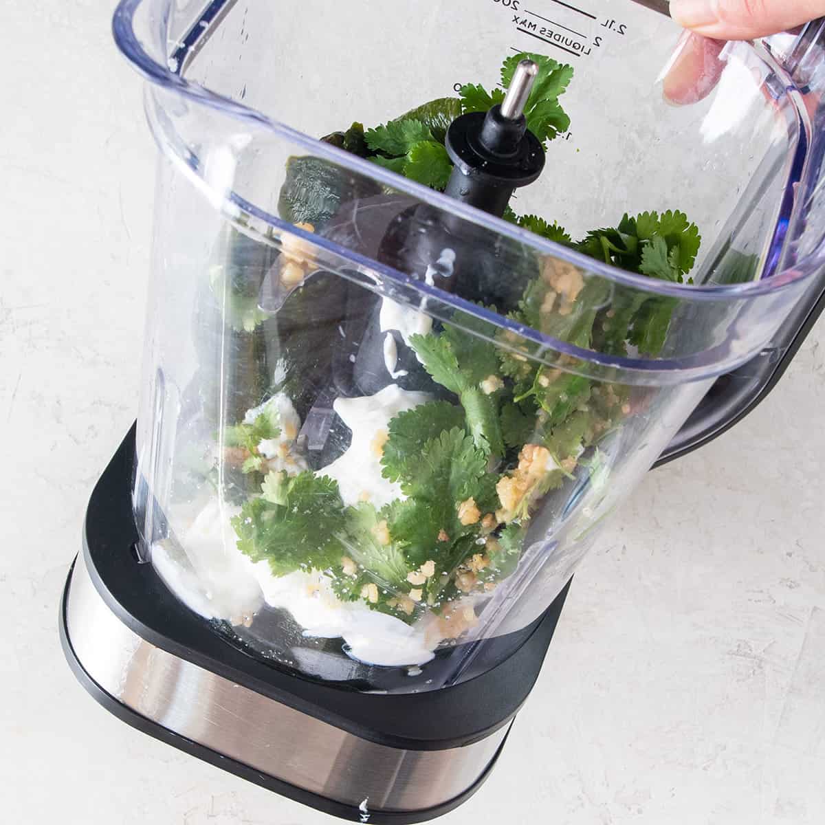 Poblano cream sauce components in a blender before being mixed.