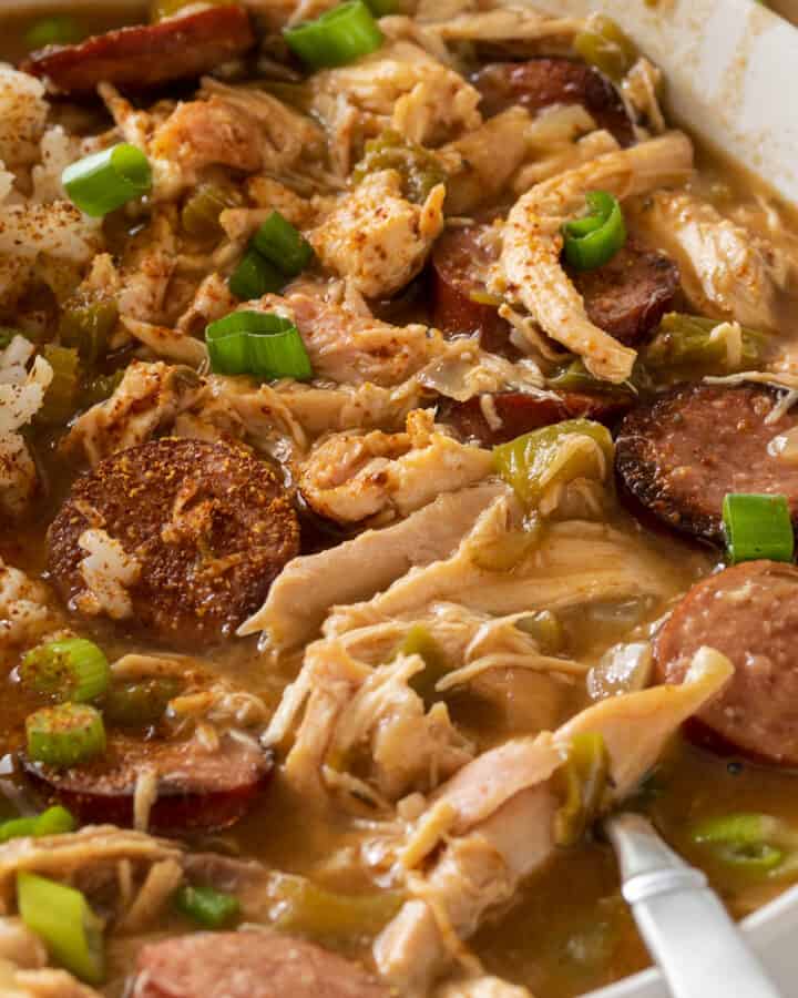 Closeup of chicken and andouille sausage gumbo in a bowl with rice.