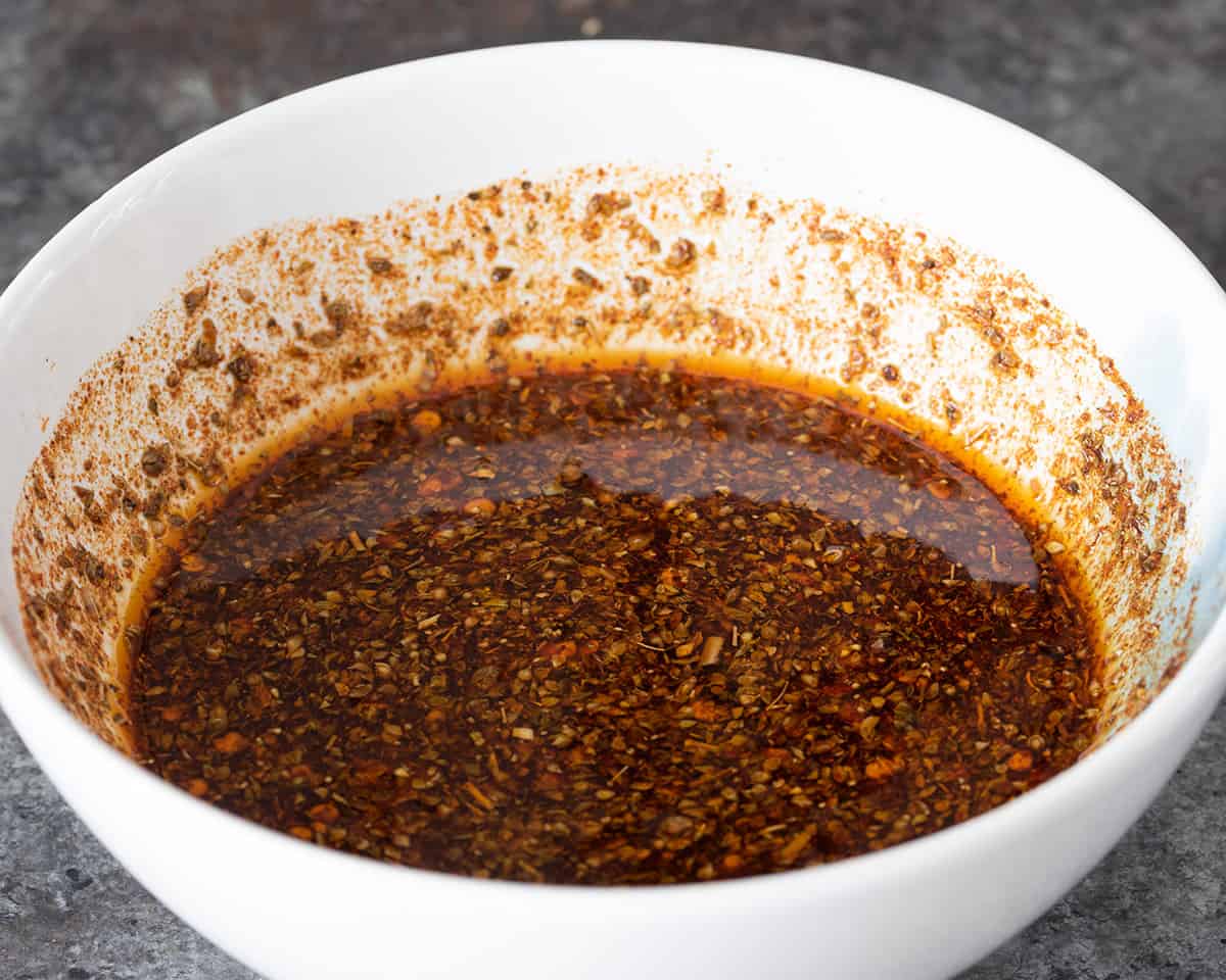 A bowl with seasoning marinade in it.