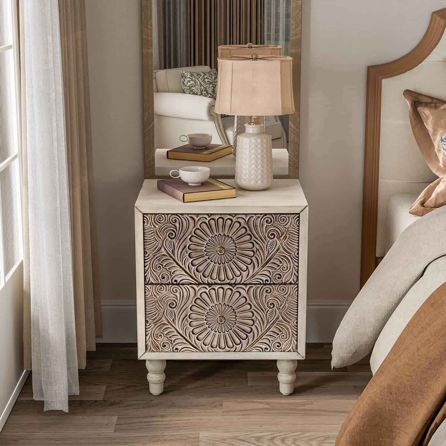 Bohemian nightstand in cream finish with carved front drawer faces and decorative pulls on spindle style legs.