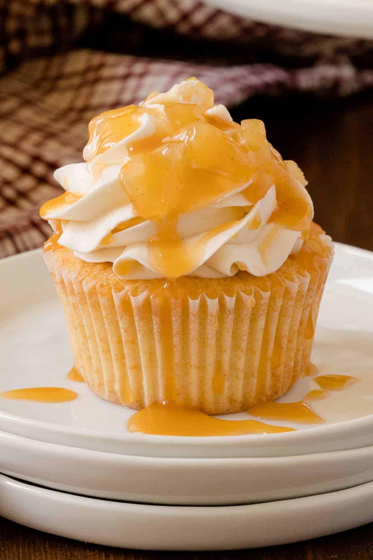 Caramel apple cupcakes topped with rich caramel icing and drizzled with buttery caramel.