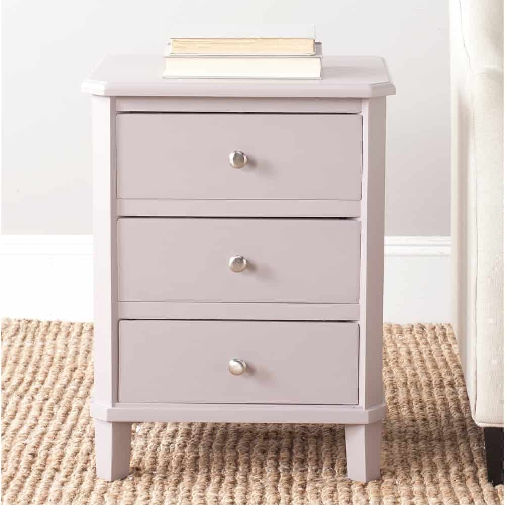 Slim gray transitional style 3-drawer nightstand with chrome hardware and rounded edges on rug.