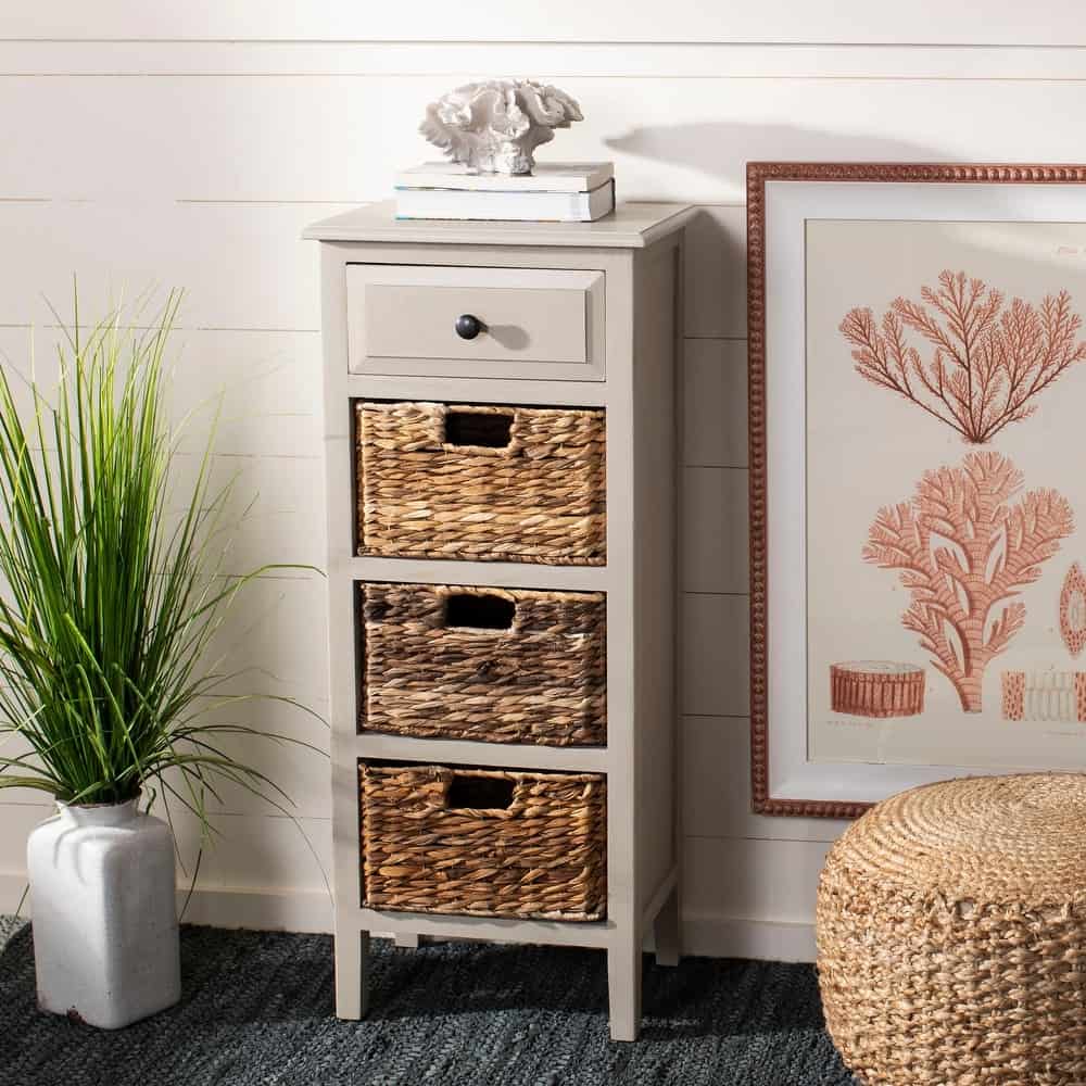 Slim gray side table with 3 wicker baskets and one top drawer in beach bedroom.