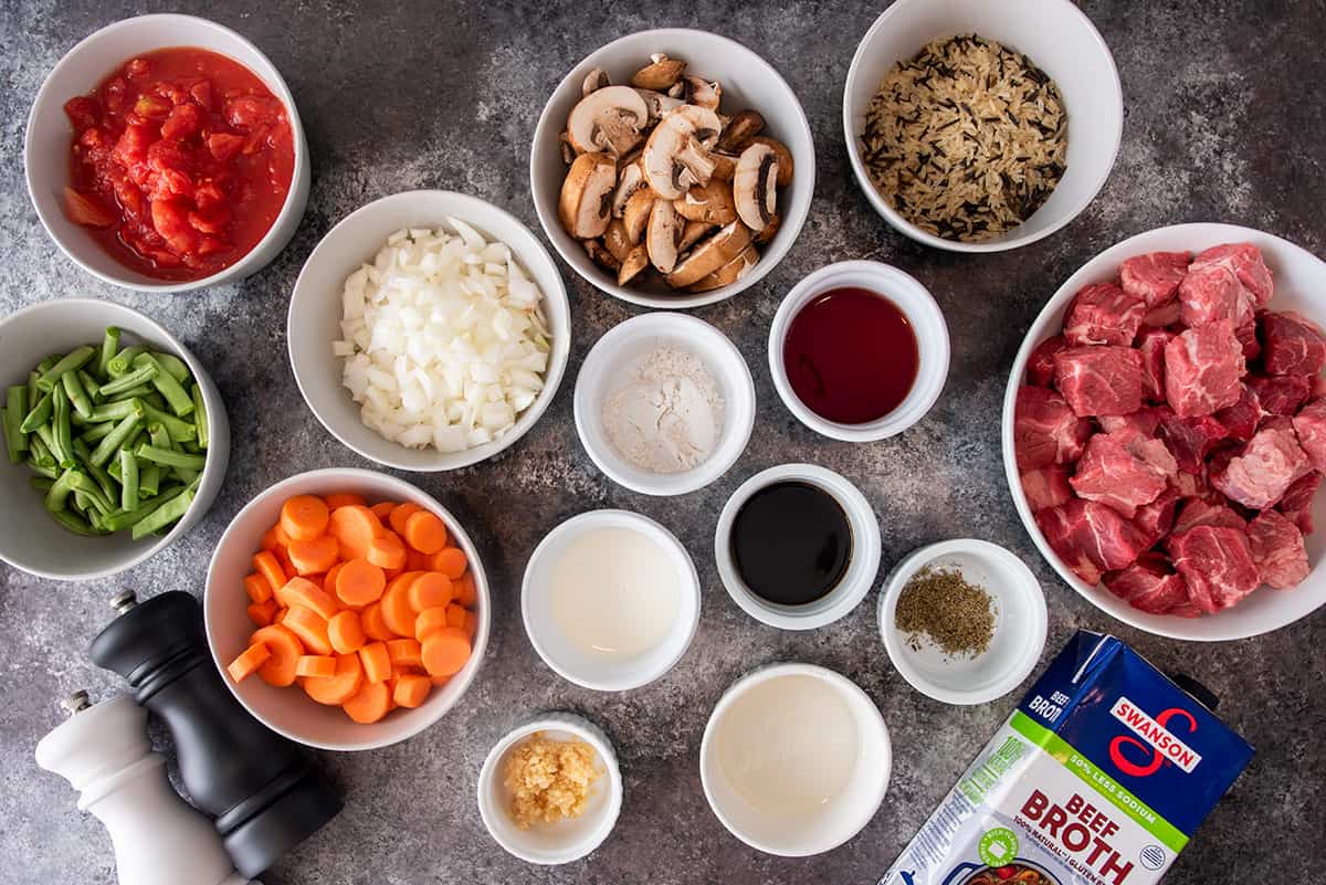 Ingredients to make Beef and rice soup laid out on a table.