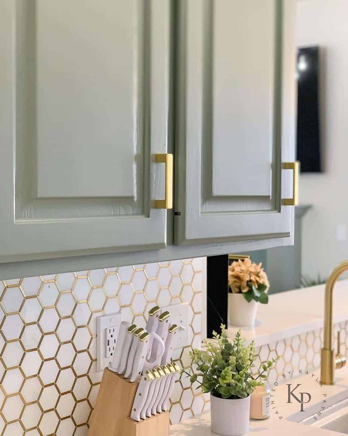 Sherwin Williams evergreen fog painted cabinets with gold hardware and accents.