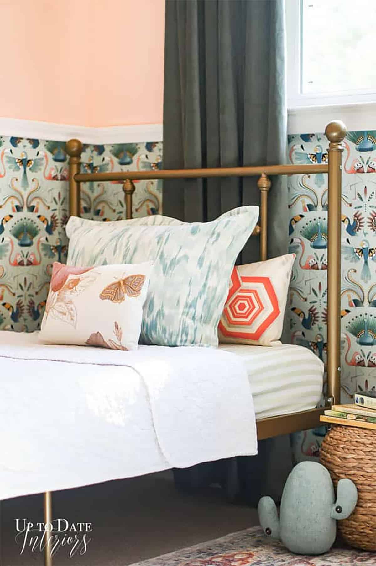 Molding and patterned wallpaper on the wall in a bohemian girl's bedroom.