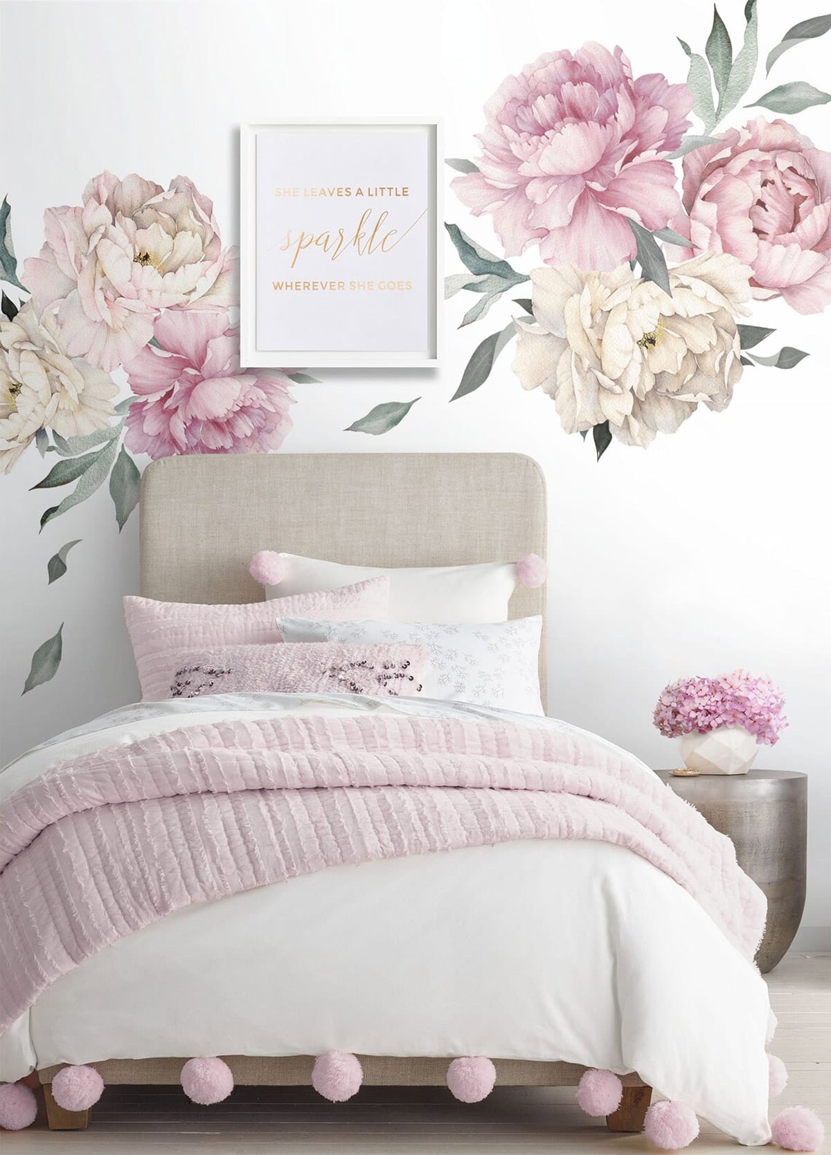 Decal watercolor peonies are the feature wall idea in a bedroom nursery.