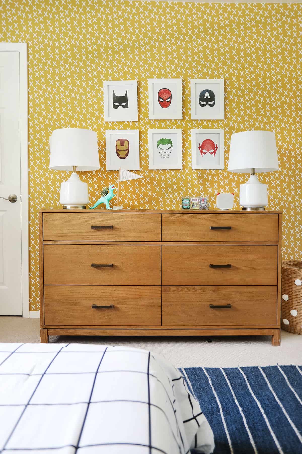 Whimsical graphic patterned mustard wallpaper in a superhero themed bedroom.