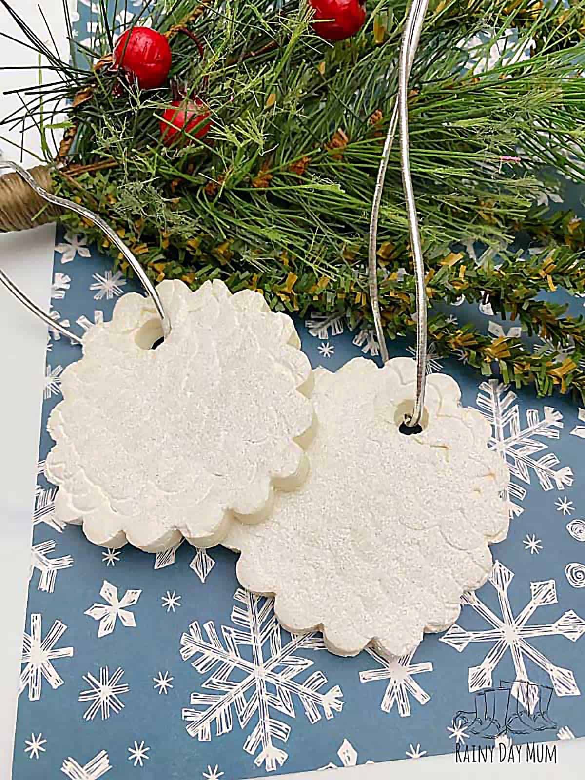 Clay textured Christmas tree ornament with fluted edges painted sparkly champagne and tied with gold string.