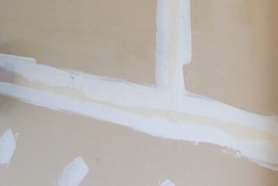 Mudded drywall with tape buried.
