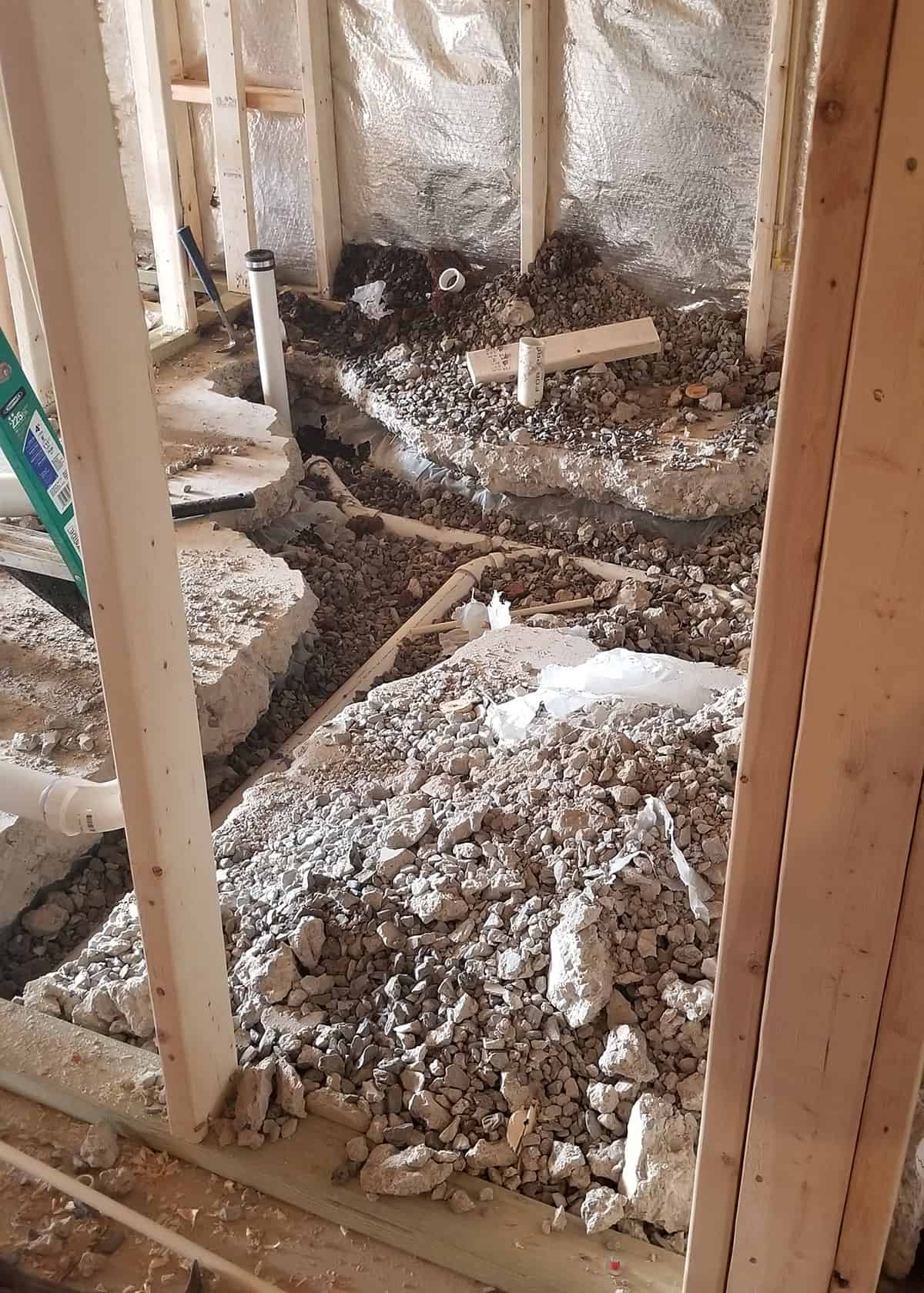 Concrete floor ripped out to reroute new plumbing for a bathroom.