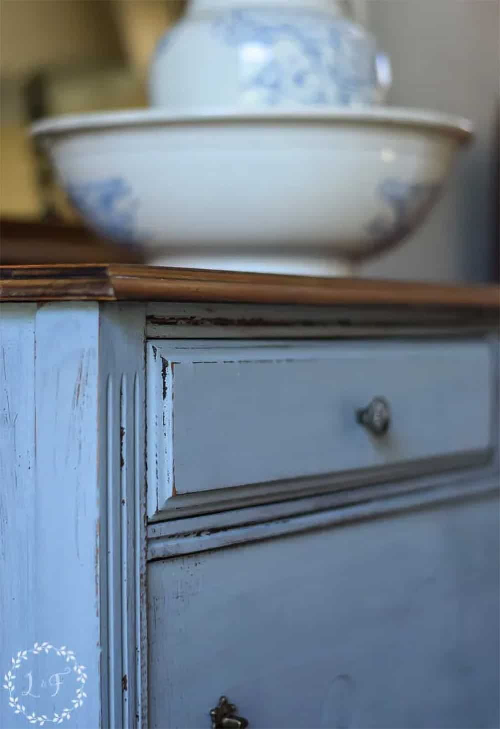 Distressed dresser painted with Miss Mustard Seed in Shutter Gray Color.