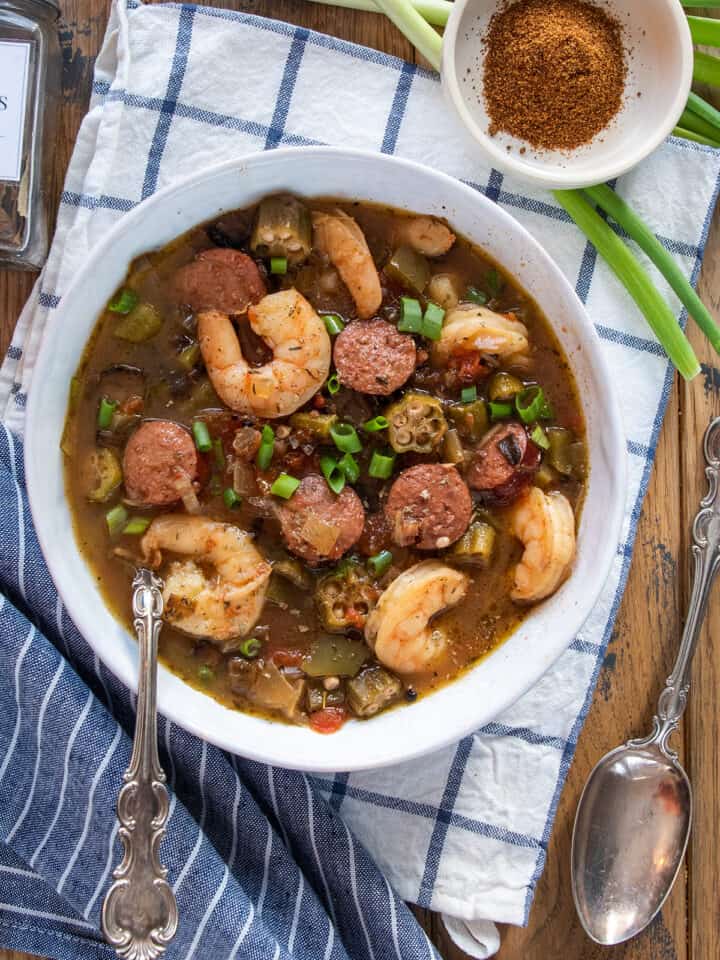 Overhead of a bowl of Creole Seafood gumbo with shrimp and sausage and okra in it.