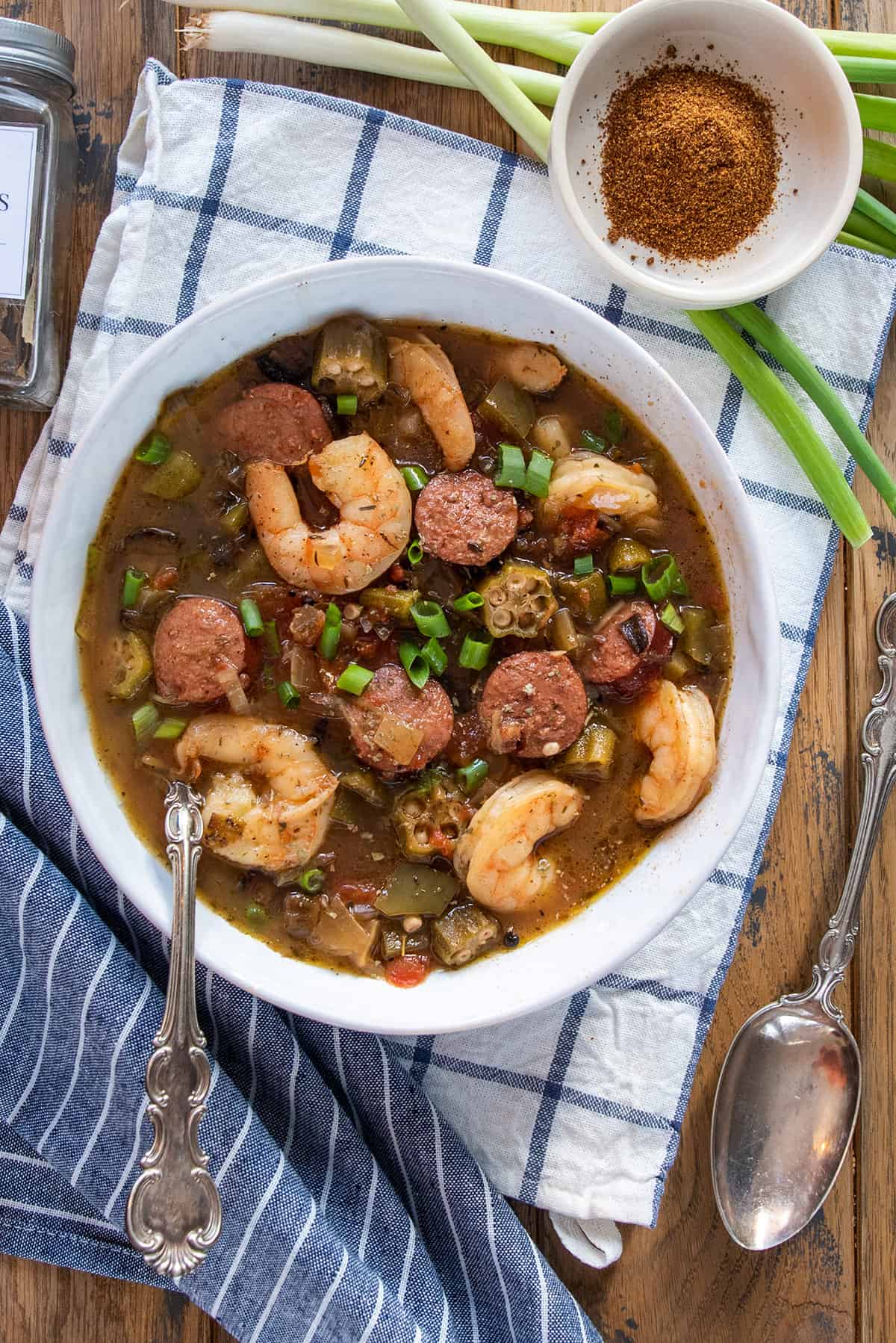 Overhead of a bowl of Creole Seafood gumbo with shrimp and sausage and okra in it.
