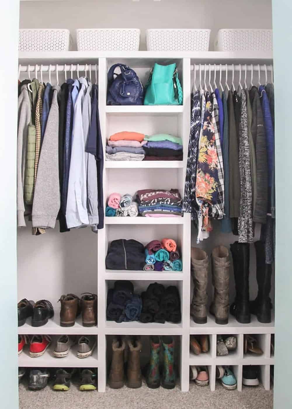 A small closet with budget custom closet organizer that is made from plywood.