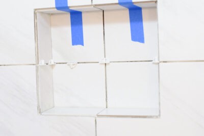 A tile nich with taped top tiles to keep them in place while the mortar dries.